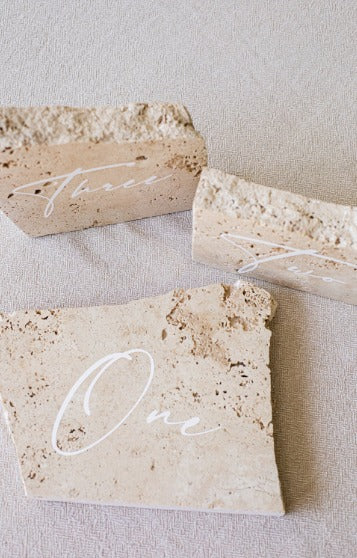 Exquisitely crafted from authentic stone and finished with a luxurious white label, this table number adds a touch of class to your décor.